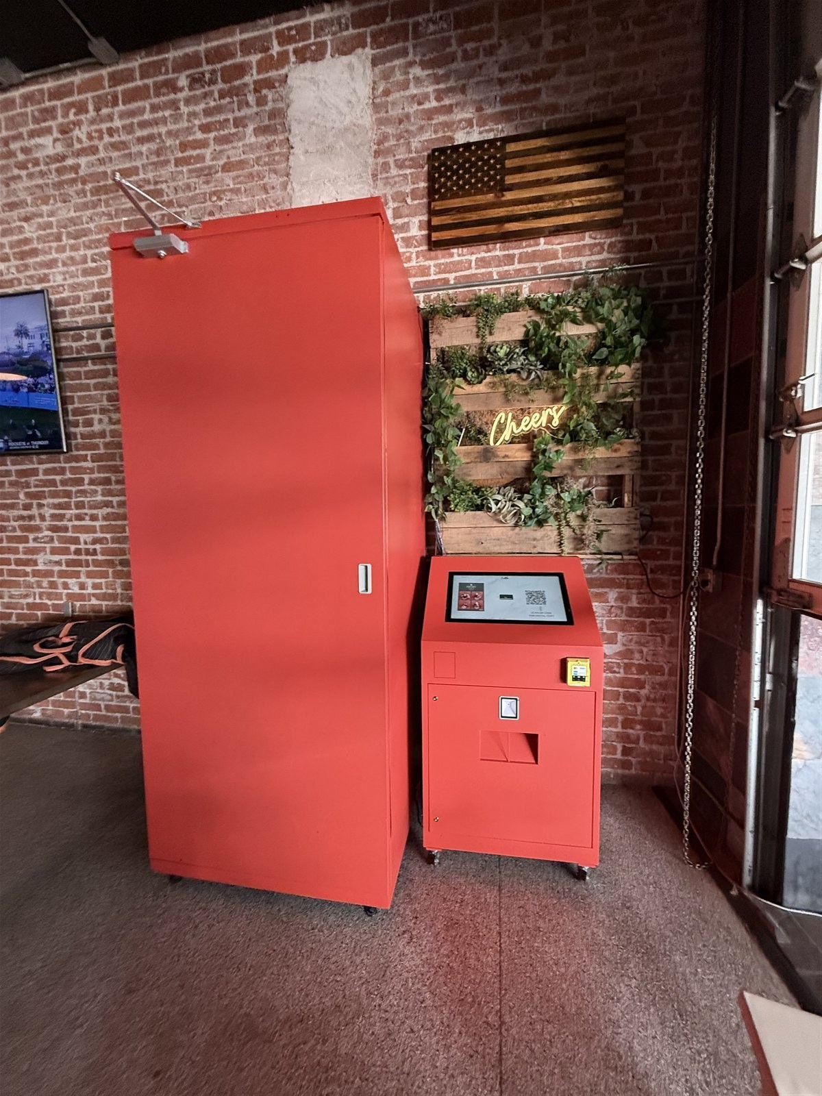 Compact oh!Shoot photo booth installation in a brick-walled venue