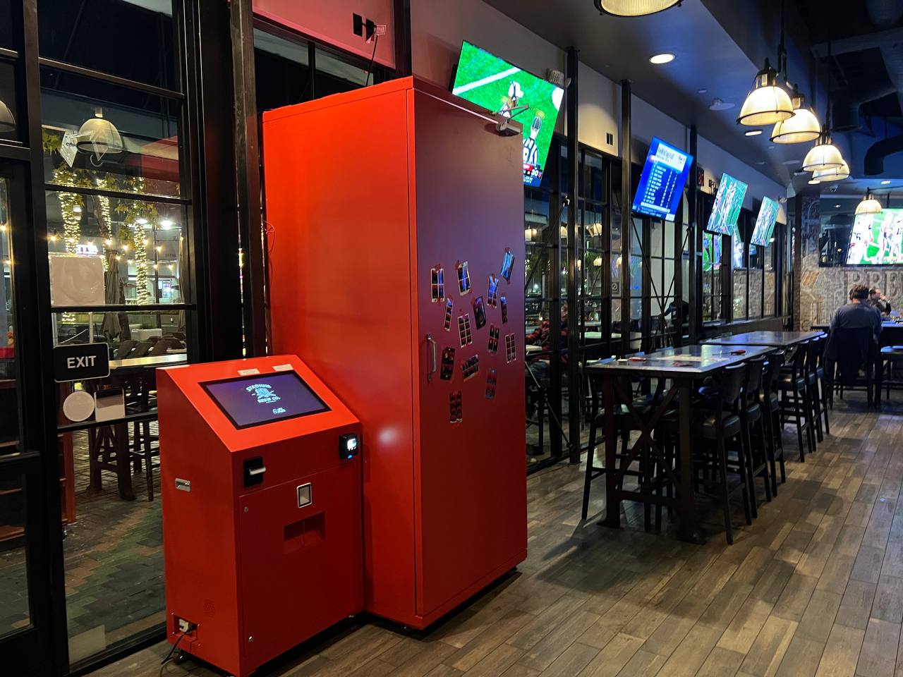 Red oh!Shoot photo booth installed inside a local sports bar